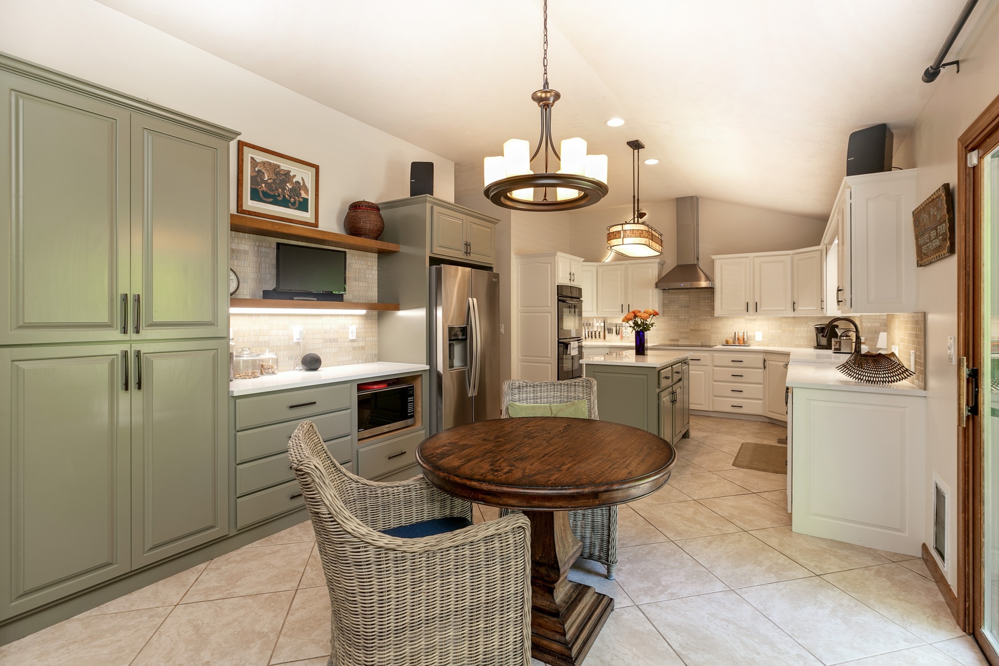 Newly remodeled kitchen with greenish and white cabinets
