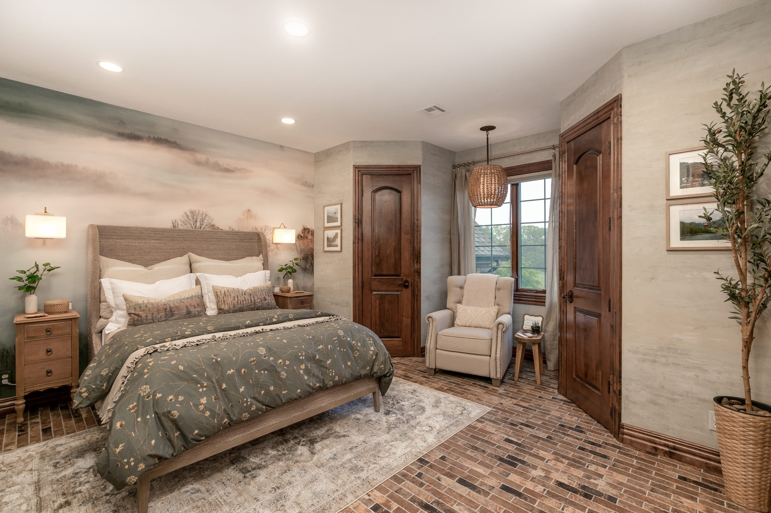 Bedroom with a large bed, neutral bedding, and a misty landscape mural across the wall behind the headboard